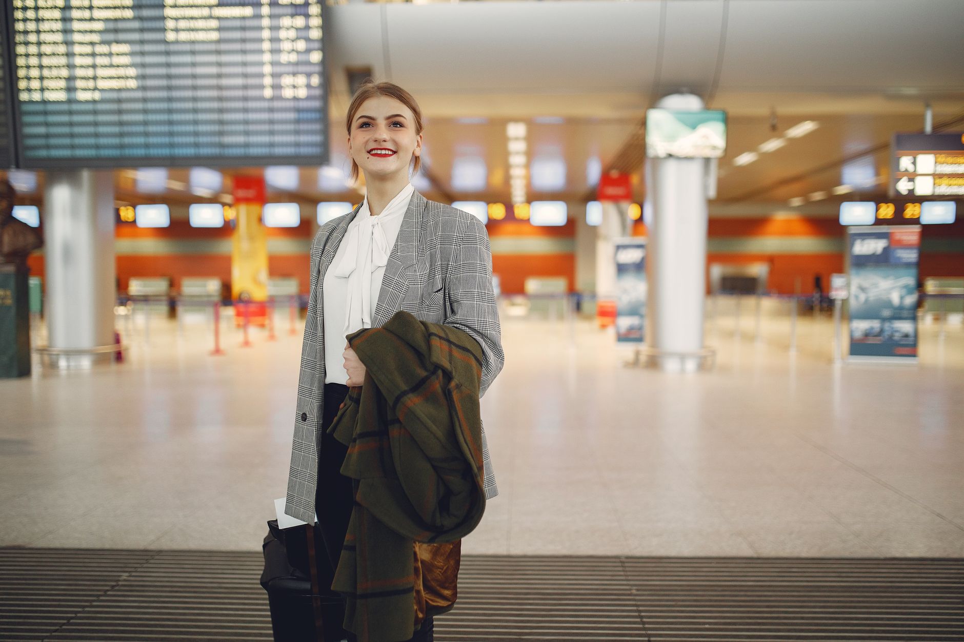 International traveler with luggage arriving at an airport terminal