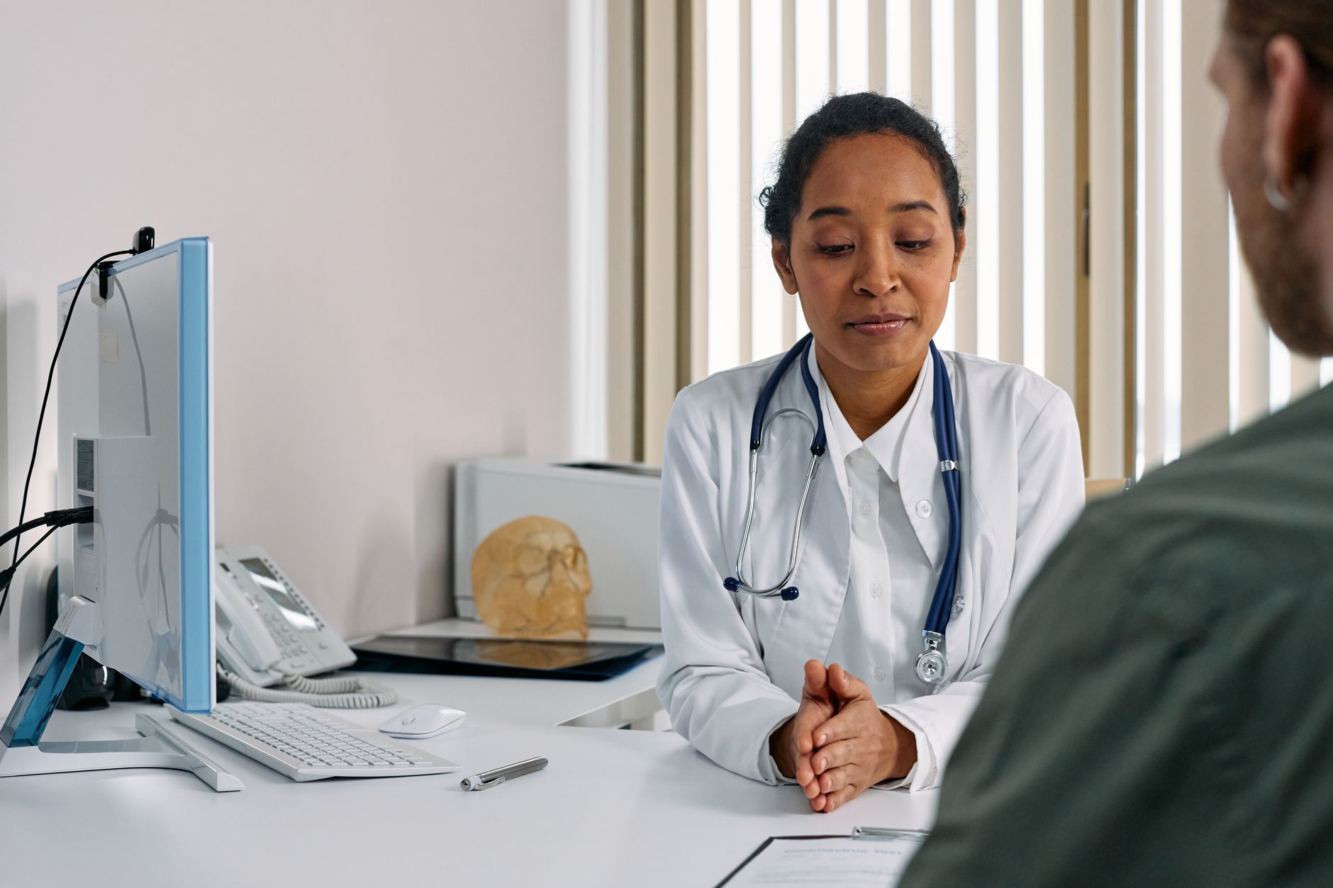 Surgeon consulting with an international patient during a pre-operative facelift consultation