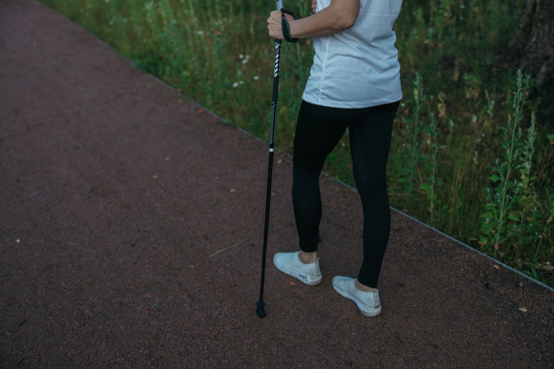 Woman taking a gentle walk in a park in Seoul, representing post-surgery recovery and wellness