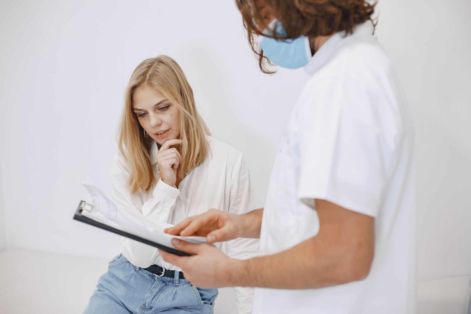 Surgeon and patient reviewing a treatment plan during a clinic consultation
