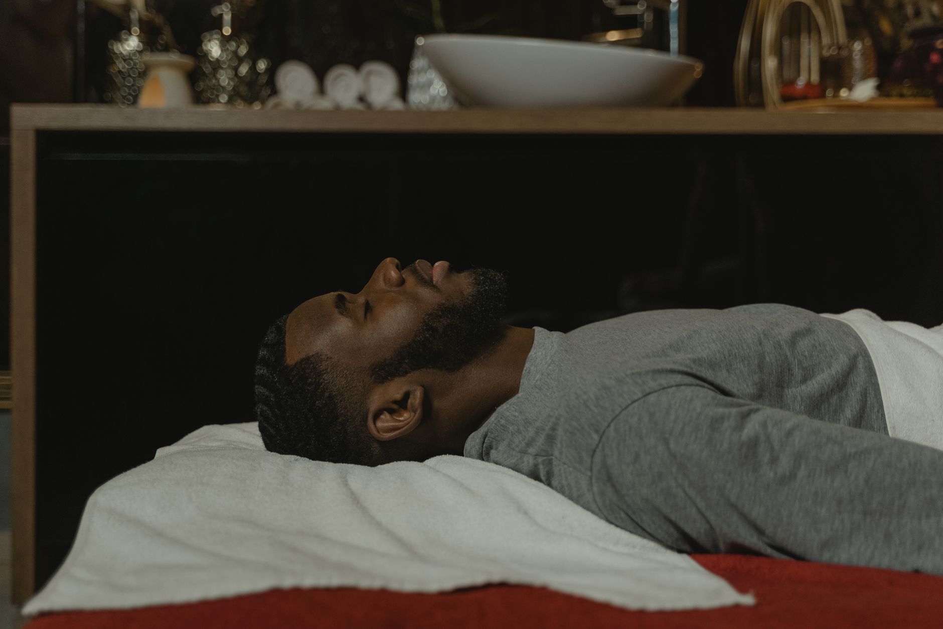 A person resting comfortably in a calm, wellness-oriented recovery environment
