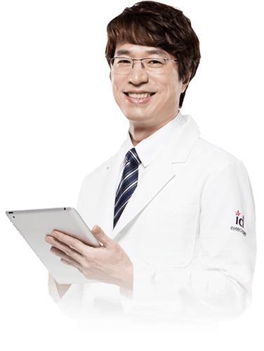 A smiling doctor in a white coat holding a tablet.