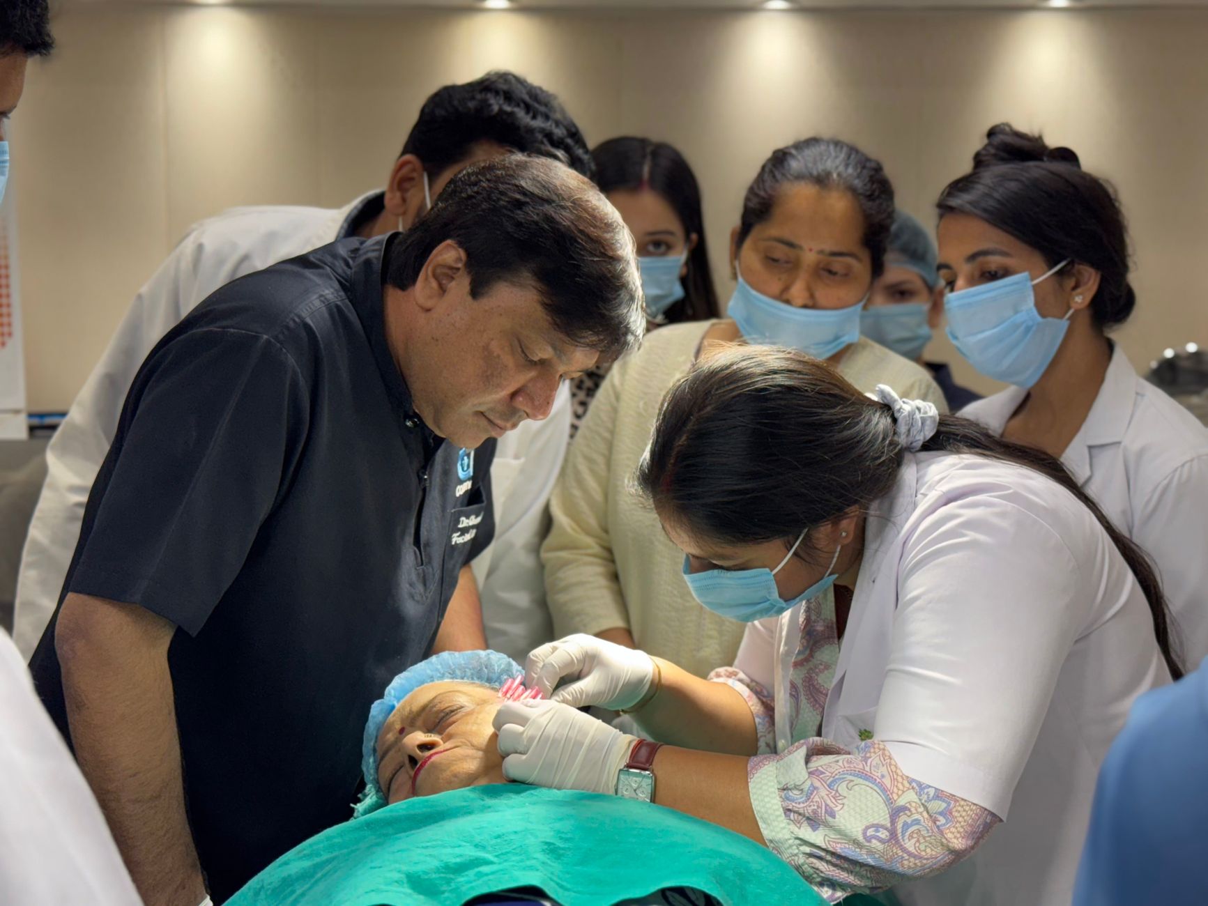 Healthcare professionals performing a cosmetic procedure in a New Delhi clinic.